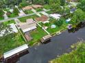 An aerial view of the homes on the canal, showcasing boat house and lush surroundings at 27714 Lois Dr, Tavares, FL 32778