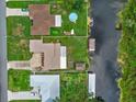 An aerial view of the canal-front homes including boat house and swimming pool at 27714 Lois Dr, Tavares, FL 32778