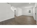 Open-concept living room with wood-look floors, and lots of natural light at 3124 Addison Blvd, St Cloud, FL 34771