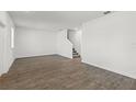 Bright living room with wood-look floors and staircase at 3124 Addison Blvd, St Cloud, FL 34771