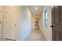 Bright hallway with neutral paint and tile floors, leading to other rooms in the house at 3202 Timber Hawk Cir, Ocoee, FL 34761