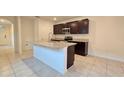 Modern kitchen with granite countertops, stainless steel appliances, and large island at 3202 Timber Hawk Cir, Ocoee, FL 34761