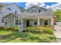 Craftsman home boasts a well-manicured lawn and neatly arranged landscaping, enhancing its curb appeal at 3226 Helen Ave, Orlando, FL 32804