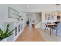 Open-concept living space with wood floors and modern furnishings with staircase access at 3226 Helen Ave, Orlando, FL 32804