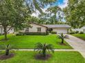 Beautifully landscaped home with a well-manicured lawn, driveway, and an attached garage, exuding curb appeal at 404 Broadview Ave, Altamonte Springs, FL 32701