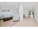 Bright living room featuring tile flooring, a neutral color palette, and comfortable seating at 4952 Longmeadow Park St, Orlando, FL 32811
