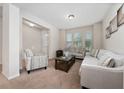 Cozy living room with plush carpeting, ample natural light, and comfortable furniture at 4952 Longmeadow Park St, Orlando, FL 32811