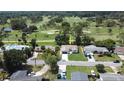 Aerial view of charming home near a golf course, showcasing the lush surroundings and neighborhood at 550 Eagle Dr, Daytona Beach, FL 32117
