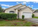 Inviting single-story home featuring a two-car garage and mature landscaping at 5559 Pats Pt, Winter Park, FL 32792