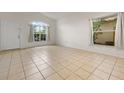 Bright and airy living room with tile flooring and large windows, creating an open feel at 5559 Pats Pt, Winter Park, FL 32792