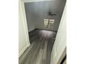Cozy bedroom featuring wood floors, natural light, and a ceiling fan at 5930 Village Cir # Ge, Orlando, FL 32822