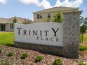 Attractive Trinity Place neighborhood sign with landscaping and newer homes in the background at 6056 Vision Rd, St Cloud, FL 34771