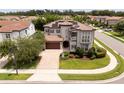 Expansive aerial view of home with tile roof, manicured lawn, and in a well-maintained neighborhood at 682 Canopy Estates Dr, Winter Garden, FL 34787