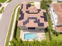 Aerial view of the home with solar panels, a private pool, and a relaxing lounge area at 682 Canopy Estates Dr, Winter Garden, FL 34787
