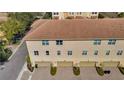 Three-story townhome featuring a three-car garage and well-maintained landscaping along the sidewalk at 813 Greybull Run, Lake Mary, FL 32746