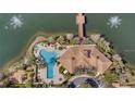 An aerial view of a community pool and lake with a wooden bridge and a clubhouse at 813 Greybull Run, Lake Mary, FL 32746