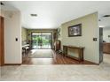 The living room features wood floors that offer access to the backyard pool through glass sliding doors at 985 Willow Run Ln, Winter Springs, FL 32708