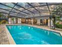 A large screened-in pool with an expansive patio, outdoor seating, and backyard entertaining space at 985 Willow Run Ln, Winter Springs, FL 32708