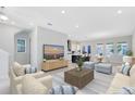 Bright and airy living room with a comfortable seating arrangement and open-concept layout, perfect for modern living at 10322 Marconi Ave, Orlando, FL 32827