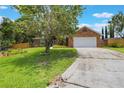 Traditional brick home featuring a two car garage and concrete driveway at 109 Hunter Point Ct, Debary, FL 32713
