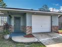 Close-up of the house with brick accents, front door and a one car garage at 1276 Comerwood Dr, Deltona, FL 32738