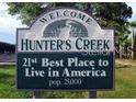 Welcome to Hunter's Creek sign displayed proudly with a lush tree backdrop at 13512 Turtle Marsh Loop # 729, Orlando, FL 32837