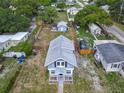 Aerial view of a two-story home with a large fenced backyard and additional storage buildings on the property at 1504 Indiana Ave, St Cloud, FL 34769