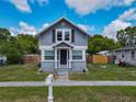 Charming gray two-story home with a well-kept front lawn and a covered entryway for curb appeal at 1504 Indiana Ave, St Cloud, FL 34769