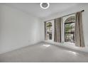 Light-filled bedroom with plush carpeting and elegant arched windows at 1560 Canopy Pasture Dr, St Cloud, FL 34771