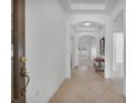 Bright foyer with tile flooring, tray ceiling, and sight lines to the living area at 1560 Canopy Pasture Dr, St Cloud, FL 34771