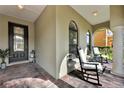 Relaxing front porch featuring comfortable rocking chairs and brick flooring at 1560 Canopy Pasture Dr, St Cloud, FL 34771