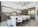 Modern kitchen with white cabinets, a center island with seating, and stainless steel appliances at 1781 Pine Ave, Winter Park, FL 32789