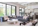Open concept living room featuring a large sectional sofa, modern furniture, and access to the backyard at 1781 Pine Ave, Winter Park, FL 32789