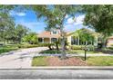 Charming one-story home with mature trees and lush landscaping at 217 Lake Cassidy Dr, Kissimmee, FL 34759