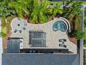 Aerial view of a private backyard oasis with pool, spa, outdoor kitchen and lounge at 2456 Northumbria Dr, Sanford, FL 32771