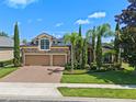 Beautiful two-story home featuring a stone facade, manicured lawn and a two car garage at 2456 Northumbria Dr, Sanford, FL 32771