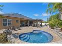 Relaxing backyard featuring a beautiful pool, patio with pergola, and lush landscaping at 2456 Northumbria Dr, Sanford, FL 32771