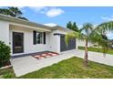 Modern single-story home featuring an attached garage and a well-kept lawn with new landscaping at 2626 Coachman Dr, Deltona, FL 32738