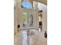 Bright foyer features decorative glass double doors, soaring ceilings, tile floors, and views into the home at 2631 Captains Ct, Kissimmee, FL 34746