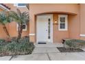 Welcoming entrance with white door, sidelight, and manicured landscaping at 2745 Corvette Ln, Kissimmee, FL 34746