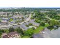 Scenic aerial view of a complex near a lake, featuring a community pool and surrounding greenery at 2893 S Osceola Ave # E6, Orlando, FL 32806