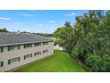 Exterior side view of the apartment showing a well-maintained lawn next to the lake at 2893 S Osceola Ave # E6, Orlando, FL 32806