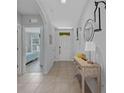Inviting entryway with neutral-toned walls, decorative accents, and a glimpse into the adjacent bedroom at 3235 Utah Dr, Deltona, FL 32738