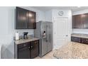 Close up of kitchen featuring granite countertops, stainless steel refrigerator at 3235 Utah Dr, Deltona, FL 32738