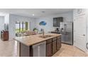 Spacious kitchen featuring granite countertops, stainless steel appliances, and a breakfast bar at 3235 Utah Dr, Deltona, FL 32738