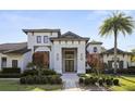 Stunning exterior of a modern home, showcasing a well-kept lawn and complementary landscaping at 3428 Chaine Du Lac Blvd, Windermere, FL 34786