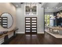 Grand foyer featuring modern front doors, high ceilings, and stylish light fixtures at 3428 Chaine Du Lac Blvd, Windermere, FL 34786
