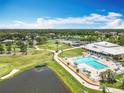 An aerial view showcasing the community pool, clubhouse, and scenic golf course with lush landscaping at 3944 Atrium Dr # 4, Orlando, FL 32822