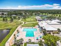 Aerial view showcasing the community pool, clubhouse, golf course, and lush landscaping at 3944 Atrium Dr # 4, Orlando, FL 32822