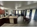 Bright open floor plan offering a spacious living room with dining area and updated kitchen at 6337 Parc Corniche Dr # 2311, Orlando, FL 32821